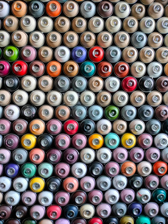 A background of colorful spray cans. Spray cans of graffiti paint.の写真素材