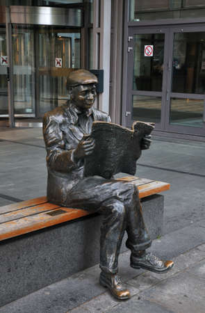 Sculpture of man with newspaper at Akersgata street in Oslo. Norwayのeditorial素材