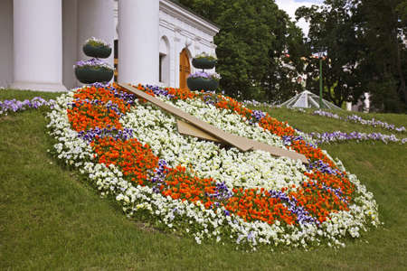 Flower clock near old townhouse in Minsk. Belarusの写真素材