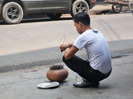Traditional burning of counterfeit dollars in Phnom Penh street. Cambodiaのeditorial素材