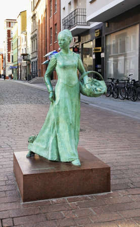 Statue of woman baker on Garbary street in Torun.  Polandのeditorial素材