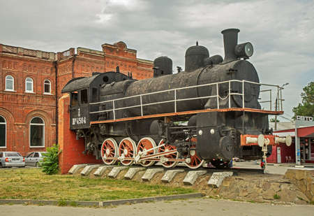 Monument-symbol Steam locomotive in front of Old railway station at Vosstaniya (Rebellion) square in...