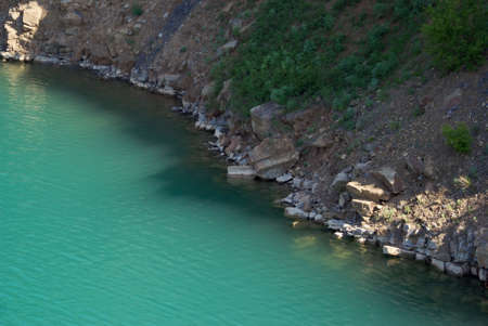 deep lake near rocks and treeの写真素材