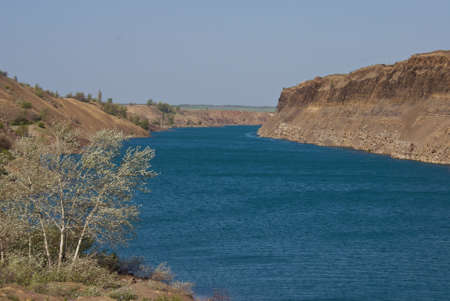 deep lake near rocks and treeの写真素材