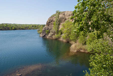 deep lake near rocks and treeの写真素材