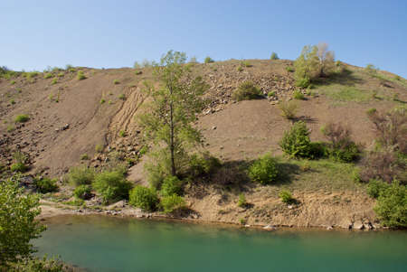 deep lake near rocks and treeの写真素材