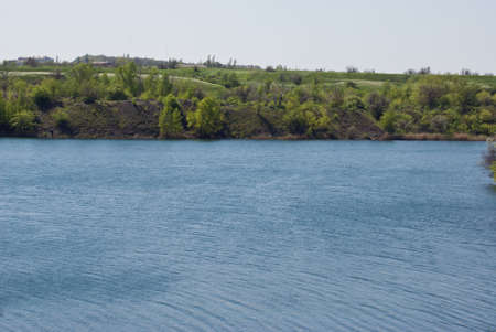 deep lake near rocks and treeの写真素材