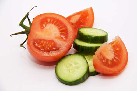 A few slices of red tomatoes and green cucumberの写真素材