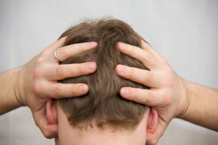 Mans hands on his haired head の写真素材