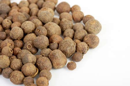 Detail shot of a pile of black peppercorns. All isolated on white background.の写真素材