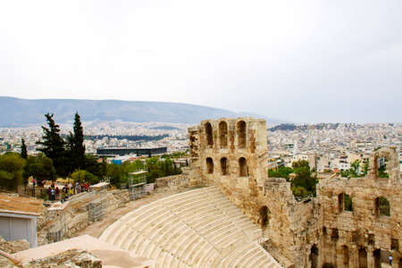 ncient theatre of Herodes Atticus is a small building of ancient Greece used for public performances of music and poetry, below on the Acropolis and in background dwelling of metropolis Athensの写真素材