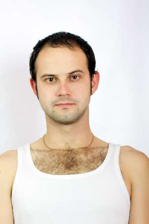 Twenty year old guy in a white shirt on the whiteの写真素材