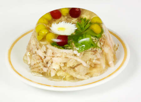 Aspic from chicken meat decorated with eggs and parsley on the whiteの写真素材