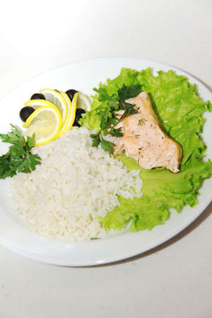 Freshly seared piece of salmon resting on a plate  with brown riceの写真素材