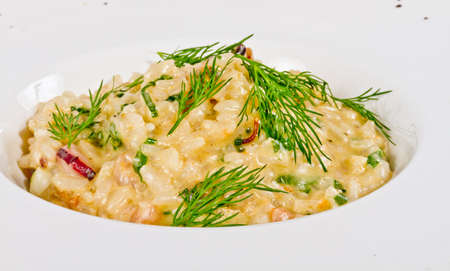 photo of delicious risotto with seafood and dill on itの写真素材