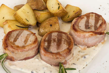 Grilled steak wrapped in bacon, with grilled vegetables, mashed potatoesの写真素材