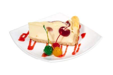 Closeup of a slice of cherry cheesecake on a white backgroundの写真素材