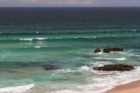 The waves fighting about deserted rocky coast of Atlantic ocean, Portugalの写真素材