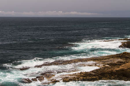 The waves fighting about deserted rocky coast of Atlantic ocean, Portugal