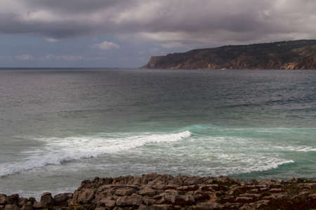 The waves fighting about deserted rocky coast of Atlantic ocean, Portugalの写真素材