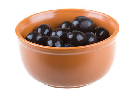 Olives black watered with olive oil in a bowl isolated on a white backgroundの写真素材