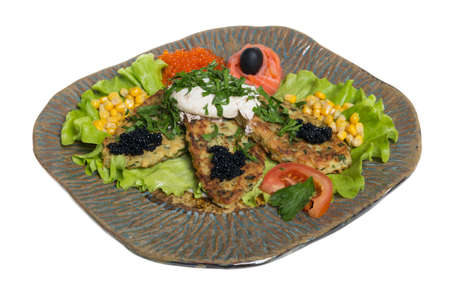 Roasted cutlets of potato with salmon on a plateの写真素材