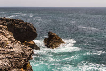 The waves fighting about deserted rocky coast of Atlantic ocean, Portugalの写真素材