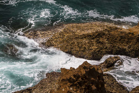 The waves fighting about deserted rocky coast of Atlantic ocean, Portugalの写真素材