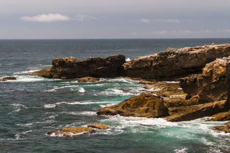 The waves fighting about deserted rocky coast of Atlantic ocean, Portugalの写真素材