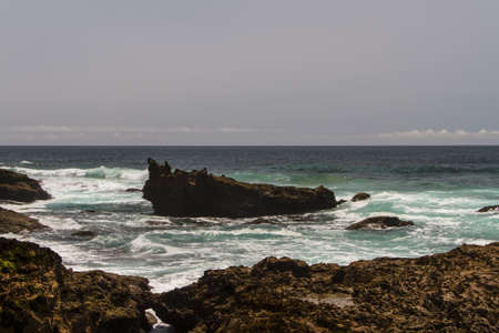 The waves fighting about deserted rocky coast of Atlantic ocean, Portugal