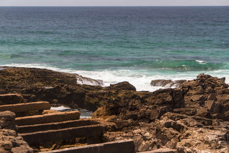 The waves fighting about deserted rocky coast of Atlantic ocean, Portugalの写真素材