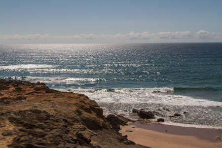 The waves fighting about deserted rocky coast of Atlantic ocean, Portugalの写真素材