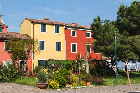 The row of colorful houses in Burano street, Italy.の写真素材