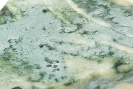 Wedge of soft blue cheese, isolated on whiteの写真素材