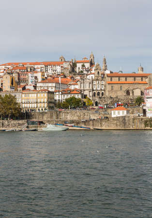 View of Porto city at the riverbank (Ribeira quarter) and wine boats(Rabelo) on River...