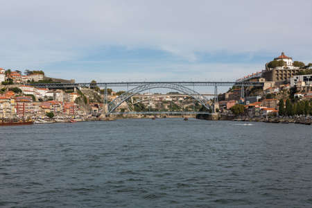 View of Porto city at the riverbank (Ribeira quarter) and wine boats(Rabelo) on River...