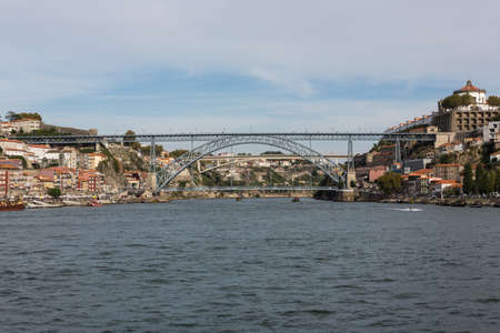 View of Porto city at the riverbank (Ribeira quarter) and wine boats(Rabelo) on River Douro(Portugal), a UNESCO World Heritage City.の写真素材