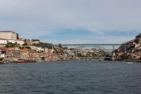 View of Porto city at the riverbank (Ribeira quarter) and wine boats(Rabelo) on River...