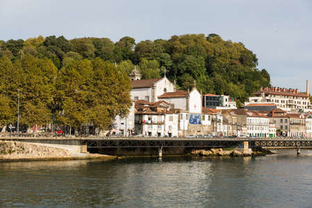 View of Porto city at the riverbank (Ribeira quarter) and wine boats(Rabelo) on River...