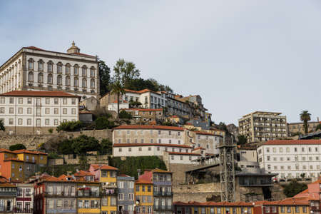View of Porto city at the riverbank (Ribeira quarter) and wine boats(Rabelo) on River...