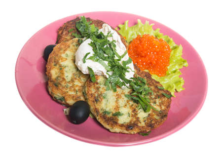 Roasted cutlets of potato with salmon on a plateの写真素材