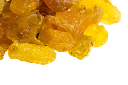 Golden raisins over whiteの写真素材