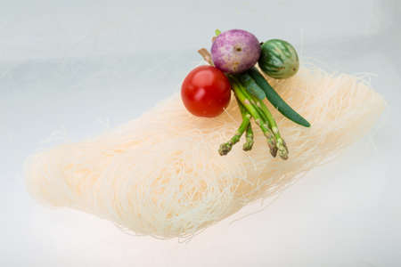 Raw rice noodles with asparagus and vegetablesの写真素材