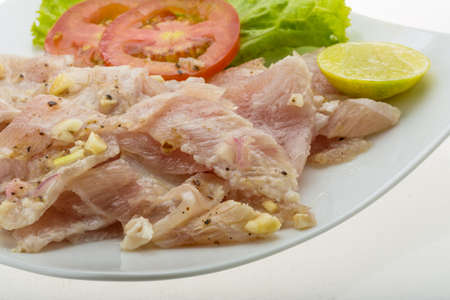 Swordfish carpaccio with lime and salad leavesの写真素材