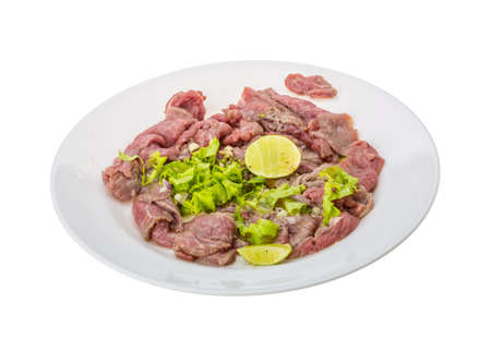 Beef carpaccio with salad leaves and limeの写真素材