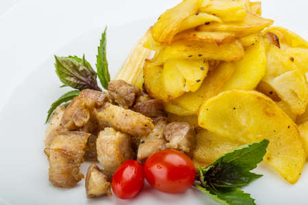 Fried pork and potato with basilの写真素材