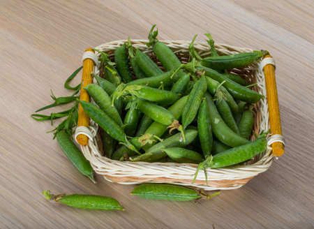 Fresh green peas in the bowlの写真素材