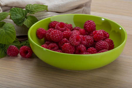 Fresh raspberry with leaf in the bowl