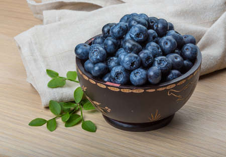 Blueberry with leaves in the bowlの写真素材