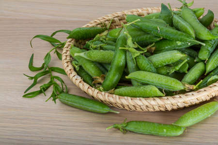 Fresh green peas in the bowlの写真素材